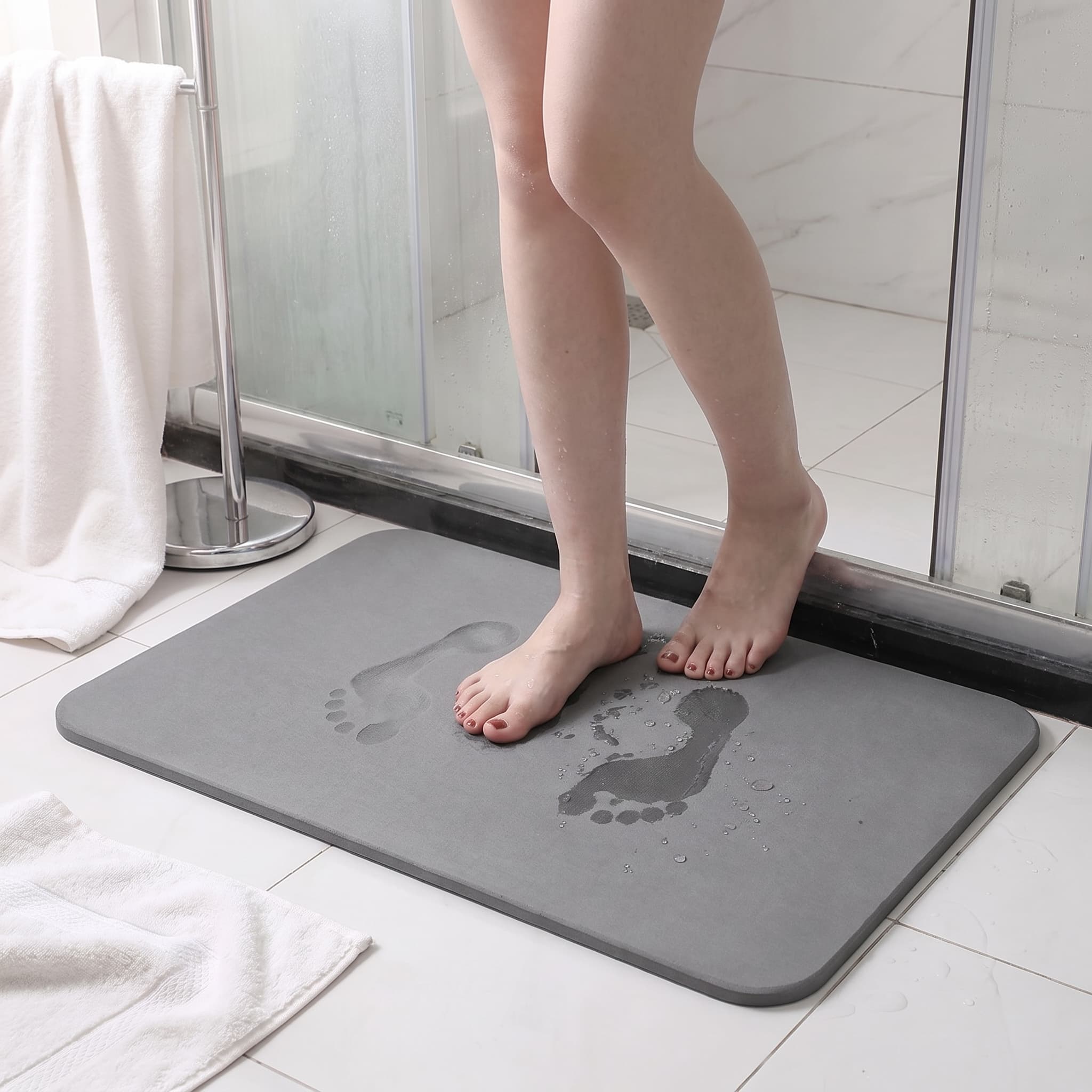 Hero 1 — Airis Mat on a bright bathroom floor, wet footprints fading